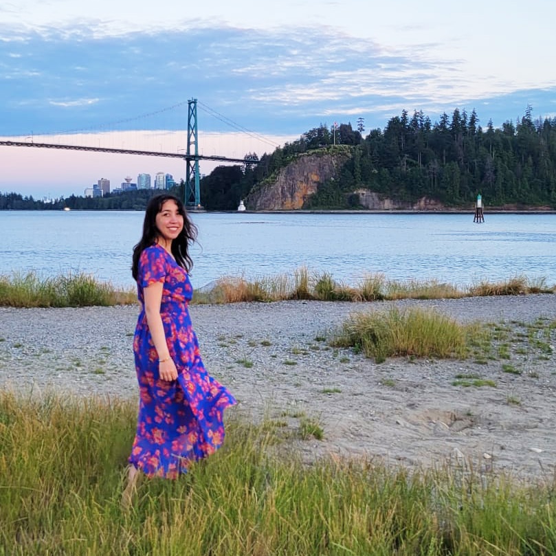 my photo against the grey background holding the phone and pointing up