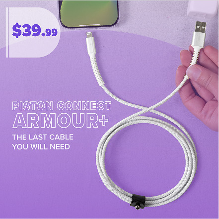 Person placing a tablet and sleeve into a backpack on grass.